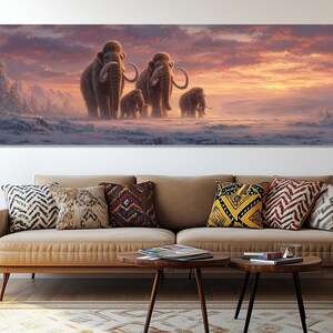 May include: A panoramic canvas print depicts a family of woolly mammoths walking across a snowy landscape. The artwork features a warm sunset with shades of orange and pink, creating a serene and prehistoric scene.