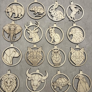 May include: Wooden animal ornaments in various designs, including a bear, mouse, rabbit, horse, elephant, deer, cat, eagle, dog, wolf, owl, fox, lion, bull, turtle, and penguin. The ornaments are laser cut with a geometric design. The text "DIGITAL DOWNLOAD" is at the top.
