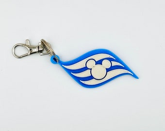 May include: A blue and white Disney Cruise Line keychain with a Mickey Mouse head logo. The keychain is attached to a silver metal ring.