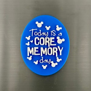May include: Blue round magnet with white Mickey Mouse silhouettes and the text "Today is a CORE MEMORY day".