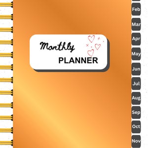 May include: A gold-coloured monthly planner with a white cover and the text "Monthly Planner" in black. The cover has a small design of red hearts.