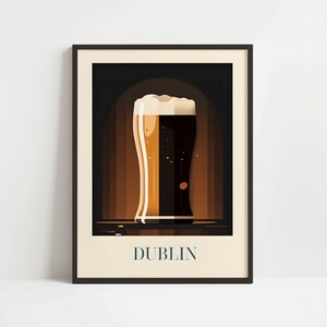 The image is a framed poster depicting a glass of beer with a frothy head, set against a dark background with a warm, orange glow.