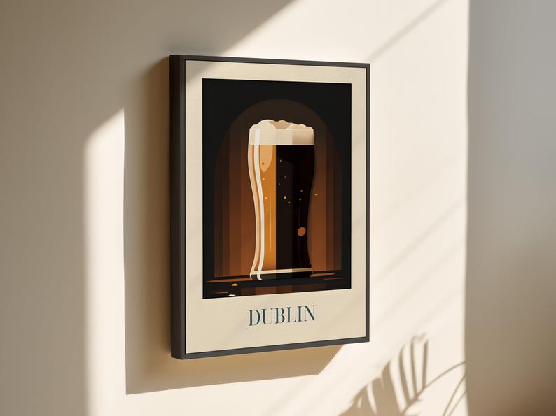 May include: A framed illustration of a glass of beer with a white head, set against a dark brown background. The text "DUBLIN" is printed in white at the bottom of the image.
