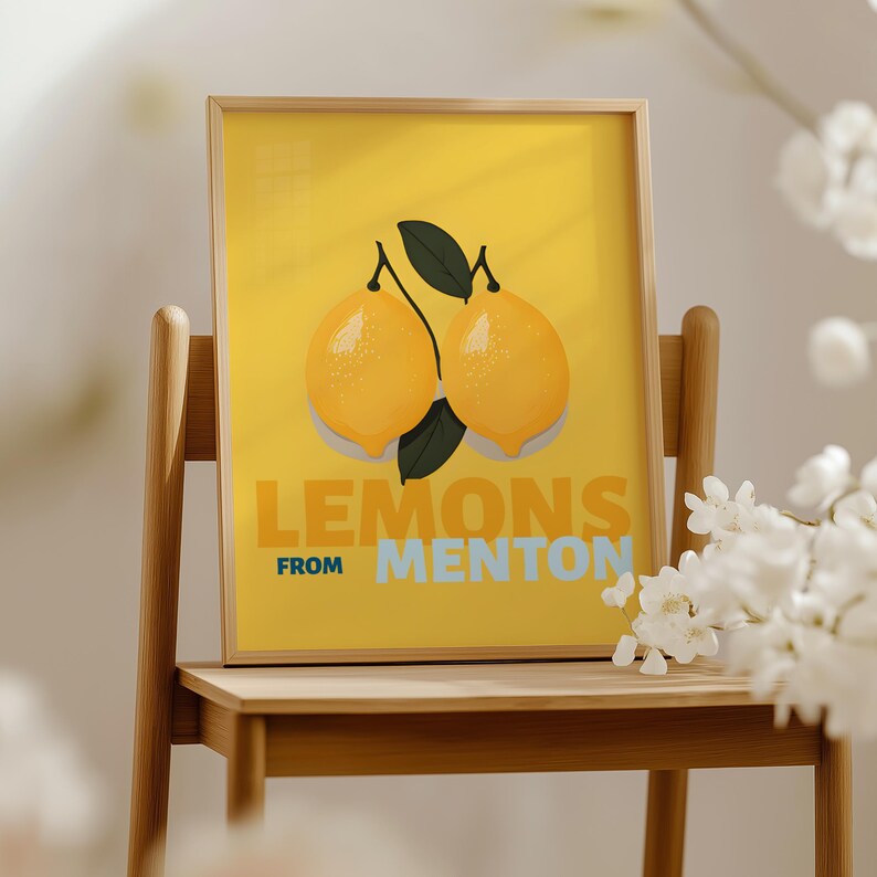 A framed poster with a yellow background and an illustration of two lemons. The text on the poster says "LEMONS FROM MENTON".