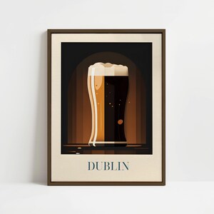 May include: A framed illustration of a glass of beer with a brown and white background. The text "DUBLIN" is printed below the glass.
