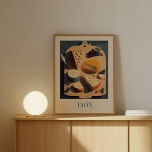 a framed poster of cheese and grapes on a wooden shelf, with a round light fixture on the shelf below it.
