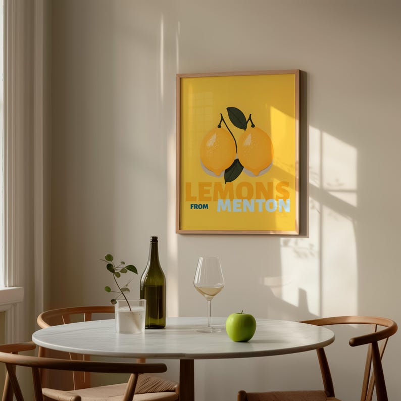 a dining table with a green apple, a bottle, and a wine glass, along with a framed poster of lemons hanging on the wall above the table.