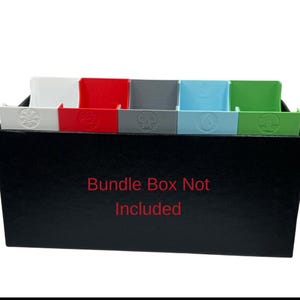 May include: A black box with multiple colored card dividers. The dividers are white, red, gray, light blue, and green. Each divider has a unique symbol. The text "Bundle Box Not Included" is in red.