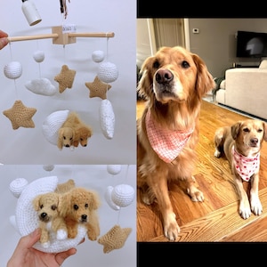 May include: A white crocheted baby mobile with a crescent moon, stars, and two small crocheted dogs. The mobile is hanging from a wooden rod. There are two golden retriever dogs in the background.