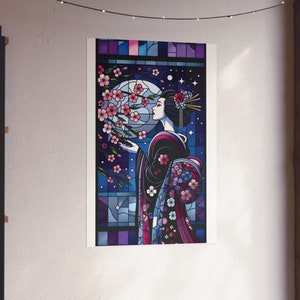 May include: A stained glass style illustration of a woman in a black kimono with pink and purple flowers. The woman is standing in front of a window with a full moon and stars in the background.