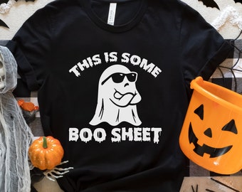 May include: Black t-shirt with a white ghost wearing sunglasses and the text "This is some boo sheet".