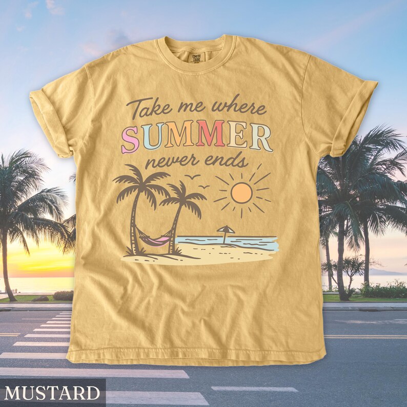 May include: Mustard-colored t-shirt with the text "Take me where SUMMER never ends." The graphic features a beach scene with palm trees, a hammock, and a sun. The shirt is a relaxed fit.