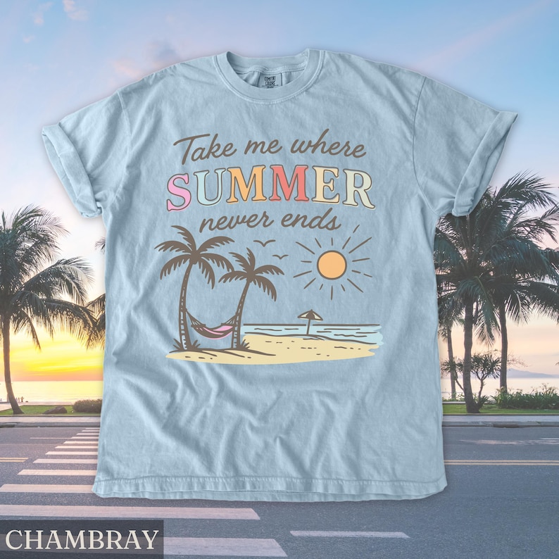 May include: Light blue t-shirt with the text "Take me where SUMMER never ends" in colorful letters. The graphic features palm trees, a hammock, a sun, and a beach scene. The shirt is made of a soft material.