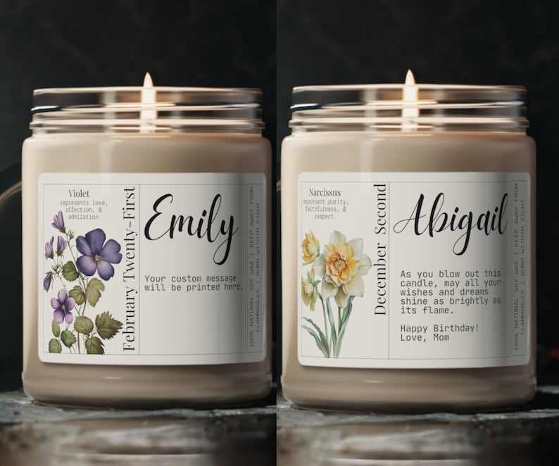 May include: Two soy candles with personalized labels. The first candle is labeled "February Twenty-First" with the name "Emily" and a violet flower illustration. The second candle is labeled "December Second" with the name "Abigail" and a daffodil flower illustration. The labels include text about the flower's meaning and a personalized message.