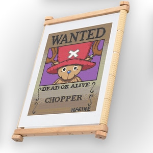 May include: A cross-stitch embroidery of a wanted poster for Chopper from the anime One Piece. The poster is brown with a purple background and features a cartoon image of Chopper with a red hat and antlers. The text on the poster reads "WANTED", "DEAD OR ALIVE?", "CHOPPER", and "MARINE".