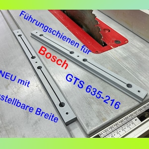 Op de afbeelding: Twee grijze metalen geleiderails voor een tafelzaag. De rails zijn gemarkeerd met "Bosch GTS 635-216" en "Führungsschienen für Bosch". De tekst "NEU mit einstellbare Breite" is ook zichtbaar.