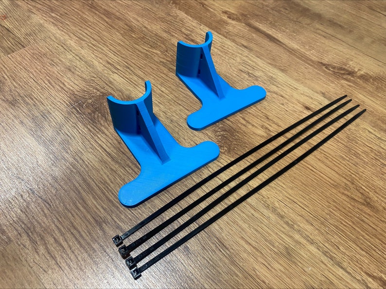 May include: Two blue plastic stands with a curved top and a flat base. Four black cable ties are included.