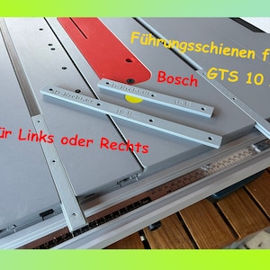 May include: Two grey metal guide rails for a Bosch GTS 10 XC table saw. The rails are labelled "D-Krebs.de" and "p-Krebs.de" with "10 R" printed on each. The text "Führungsschienen für Bosch GTS 10 XC" and "für Links oder Rechts" is printed in red on a white background.