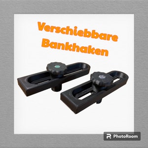 Könnte beinhalten: Zwei schwarze verstellbare Werkbankhaken mit einem Schiebemechanismus und einem gerändelten Knopf. Der Text "Verschiebbare Bankhaken" ist im Bild sichtbar.
