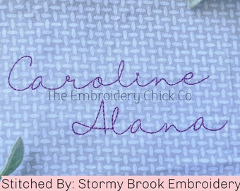 May include: Purple embroidered names "Caroline" and "Alana" on a light blue fabric with a white pattern. The text "The Embroidery Chick Co." is below the name "Caroline". The text "Stitched By: Stormy Brook Embroidery" is at the bottom of the image.