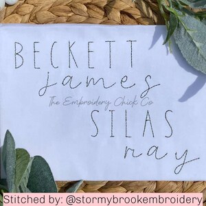 May include: White fabric with embroidered names Beckett, James, Silas, and May. The text "The Embroidery Chick Co." is also embroidered on the fabric.