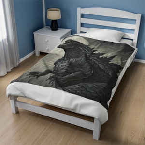 May include: A white twin-sized bed with a black and white comforter featuring a Godzilla-like monster roaring at a full moon. The comforter is made of soft, comfortable microfiber.