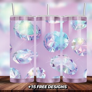 May include: Three stainless steel tumblers with a pink background and iridescent diamond pattern.  The tumblers have a silver lid and a straw.