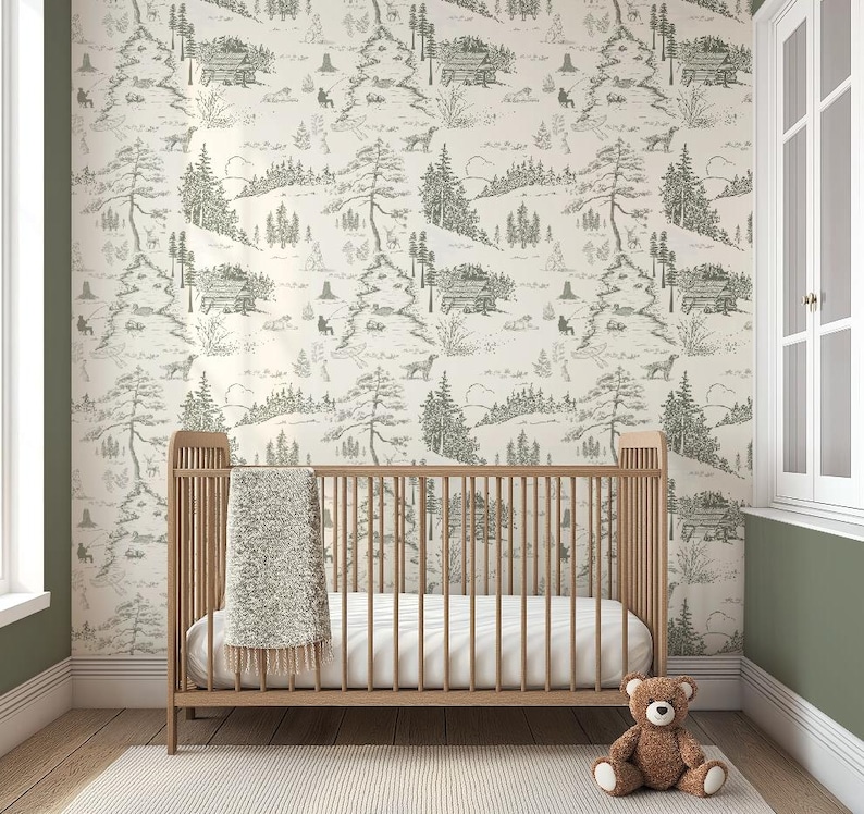 May include: A nursery scene featuring a wooden crib with a white mattress and a soft, light-colored blanket. The wall is adorned with wallpaper depicting a forest scene in shades of gray and white. A brown teddy bear sits on the floor.