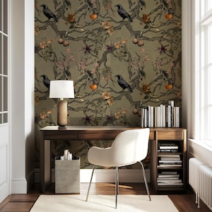 May include: A home office with a dark wood desk, a white chair, and a patterned wallpaper featuring crows, branches, and fruit. A lamp with a beige shade sits on the desk, and a small side table holds office supplies. Books are on a shelf.