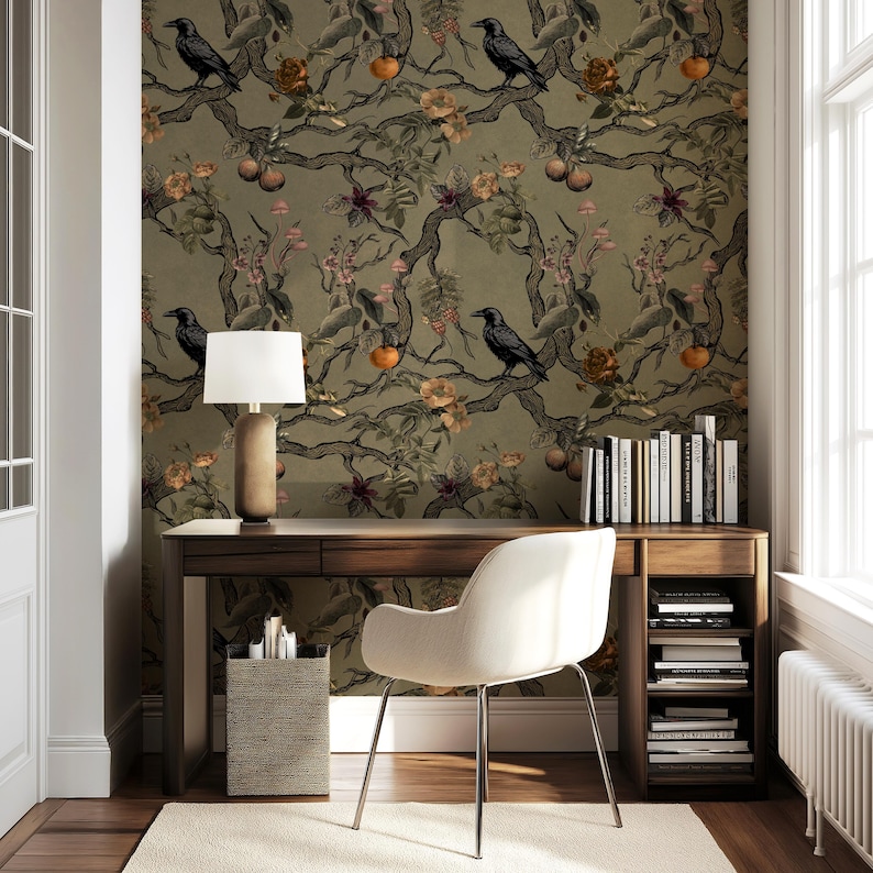 May include: A home office with a dark wood desk, a white chair, and a patterned wallpaper featuring crows, branches, and fruit. A lamp with a beige shade sits on the desk, and a small side table holds office supplies. Books are on a shelf.