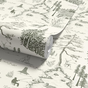 May include: A roll of wallpaper featuring a detailed forest scene in shades of green and cream. The design includes trees, deer, a dog, a fisherman, and other outdoor elements. The pattern is a repeating design.