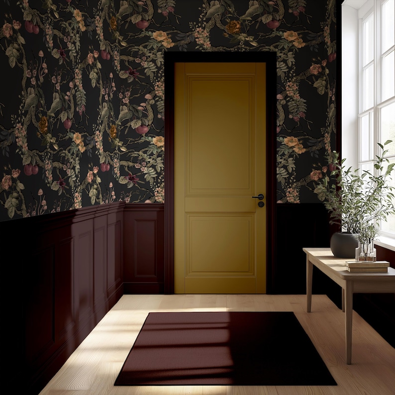 May include: Interior scene featuring a mustard-colored door, dark floral wallpaper, and a burgundy rug. The walls are painted in dark colors, with a wooden paneling. A small wooden table holds a plant and books, and a window provides natural light.