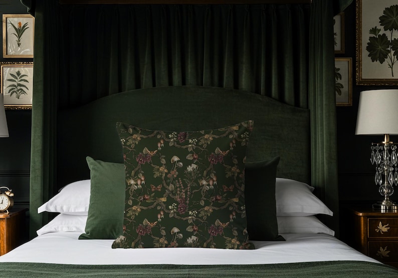 May include: A bed with a dark green headboard and matching bedding. Decorative pillows with floral patterns in shades of green, brown, and burgundy are arranged on the bed. The room has a luxurious, vintage aesthetic.