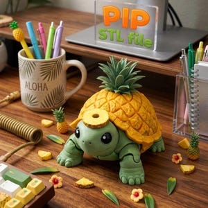 May include: A whimsical, green turtle figurine with a pineapple shell and head. The turtle is surrounded by miniature pineapples, flower accents, and a mug that says "ALOHA". Pens and a keyboard are also visible.