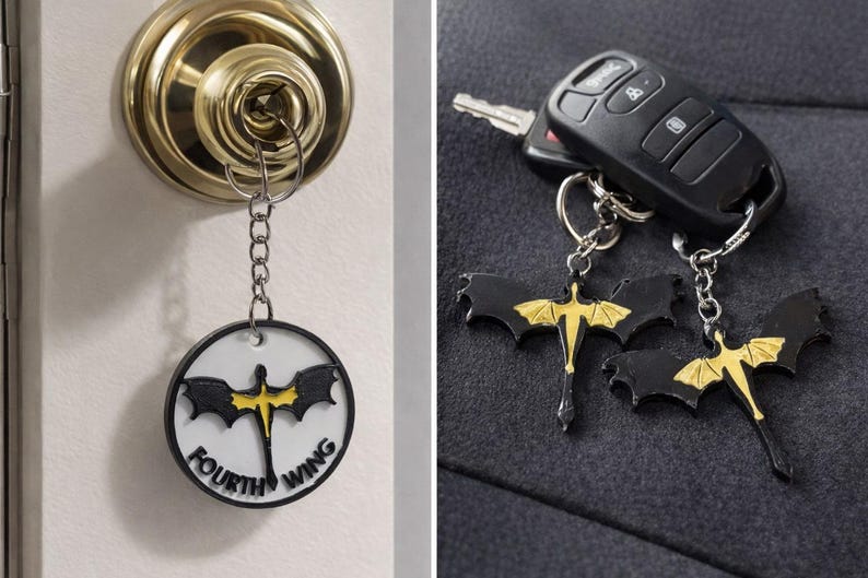 May include: Keychains with a black and gold dragon design. One keychain is attached to a key in a door lock, and the other two are next to a car key fob. The keychains have a circular design with the words "FOURTH WING".
