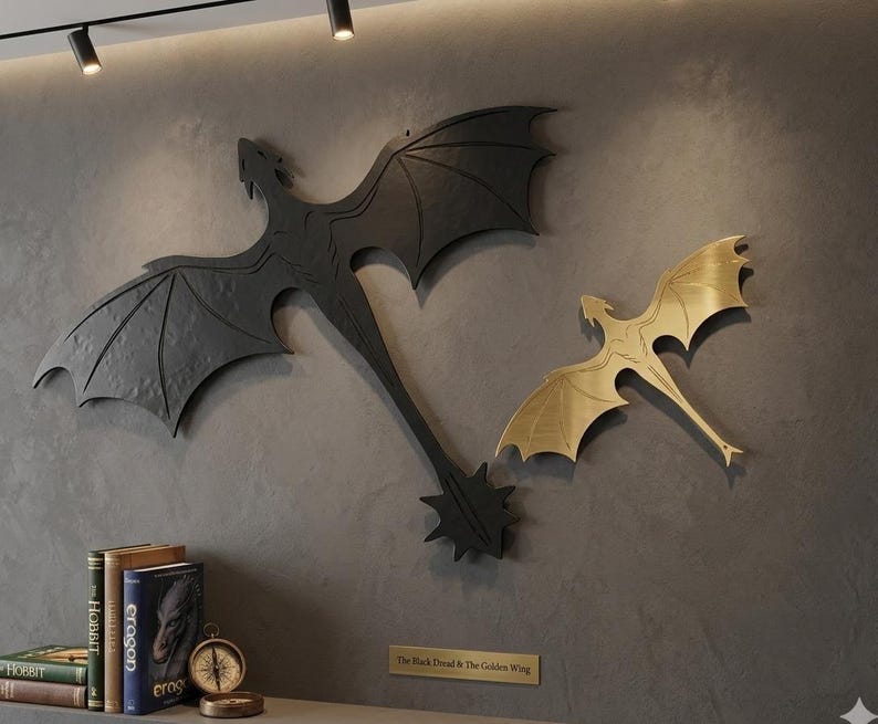 May include: Two metal dragon wall art pieces. One is black, the other is gold. The black dragon has a long tail with a starburst design. The gold dragon is smaller. The text on the plaque reads "The Black Dread & The Golden Wing."
