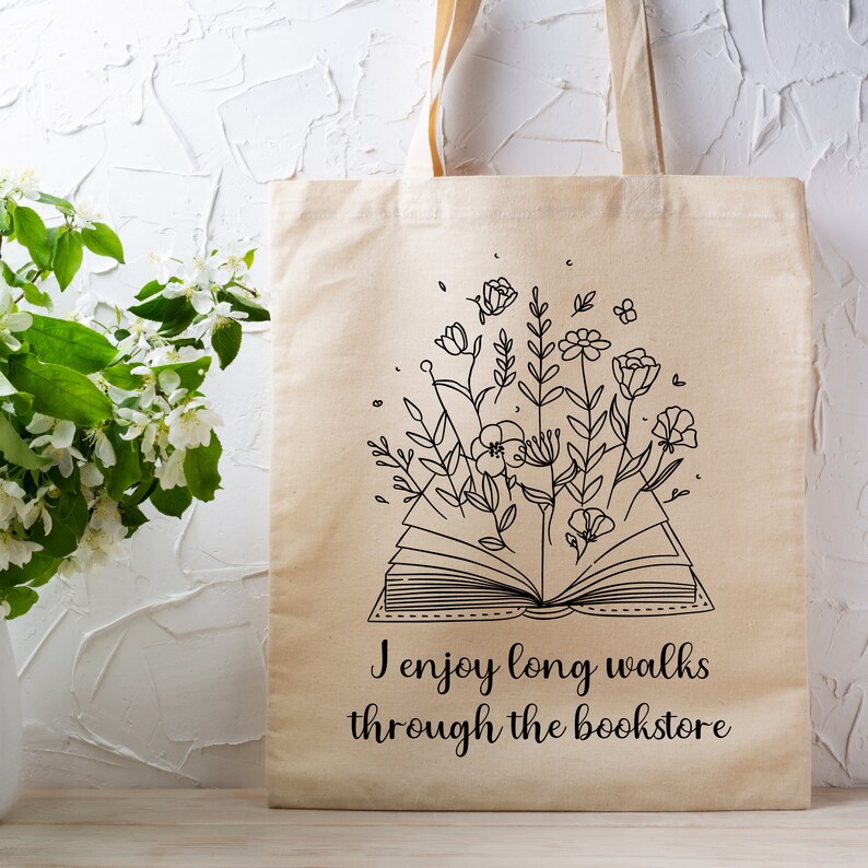 Bookish Tote, Booktrovert Tote Bag, Book Lovers Book Bag, Gift for English Teacher, Librarian Gift with funny quote that says I enjoy long walks through the bookstore. Cottagecore wildflowers and book. Cute bag for booksellers and book nerds.