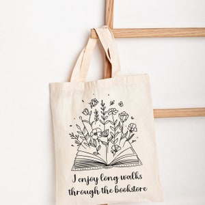 Bookish Tote, Booktrovert Tote Bag, Book Lovers Book Bag, Gift for English Teacher, Librarian Gift with funny quote that says I enjoy long walks through the bookstore. Cottagecore wildflowers and book. Cute bag for booksellers and book nerds.