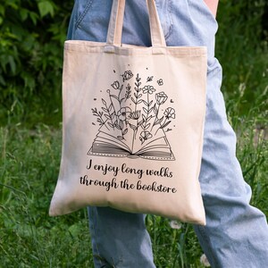 Bookish Tote, Booktrovert Tote Bag, Book Lovers Book Bag, Gift for English Teacher, Librarian Gift with funny quote that says I enjoy long walks through the bookstore. Cottagecore wildflowers and book. Cute bag for booksellers and book nerds.