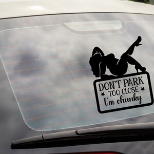 May include: Black and white car window sticker with a silhouette of a woman and the text "Don't park too close I'm chunky".