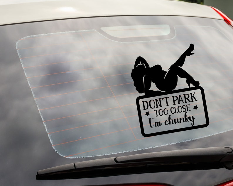 May include: Black and white car window sticker with a silhouette of a woman and the text "Don't park too close I'm chunky".