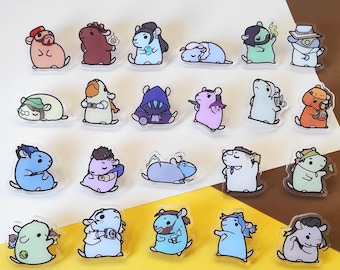 May include: A collection of 20 colorful enamel pins featuring cartoon hamsters in various poses and outfits. The pins are on a white background with a brown surface in the background.