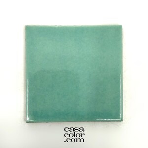 May include: A square ceramic tile in a light teal green color.