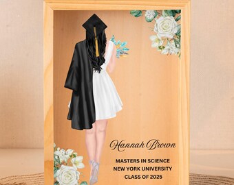 May include: A wooden shadow box with a graduation cap and gown illustration. The text reads "Hannah Brown, Masters in Science, New York University, Class of 2025".