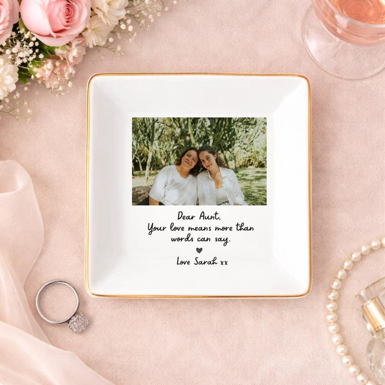 May include: Square white ceramic trinket dish with a gold rim, featuring a photo of two people and the text "Dear Aunt, Your love means more than words can say. Love Sarah xx."