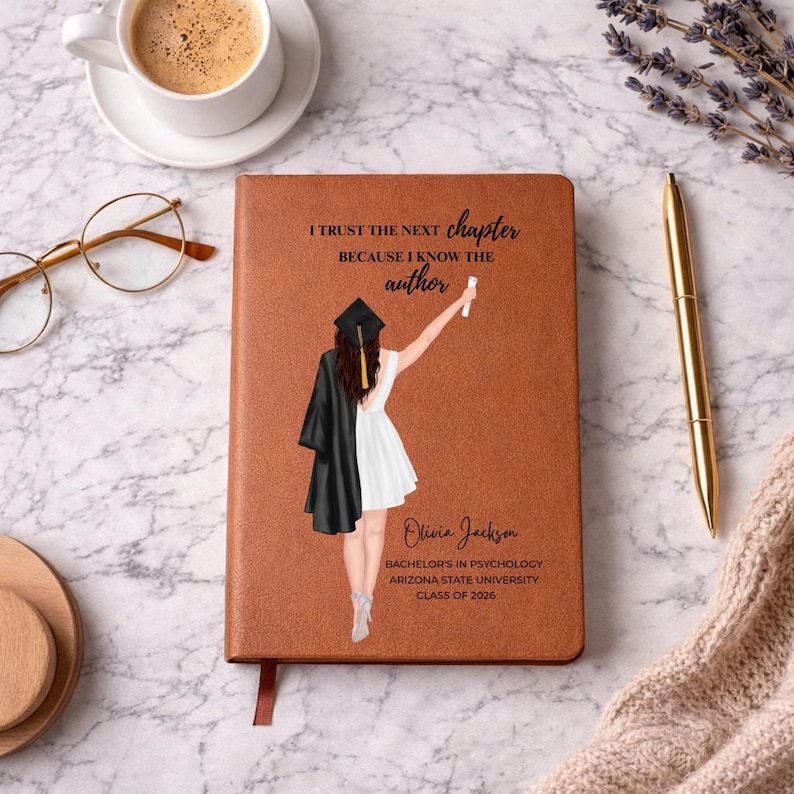 May include: A brown leather journal with the text "I trust the next chapter because I know the author." A graduation illustration is featured. The journal also includes the name "Olivia Jackson", degree, university, and graduation year.