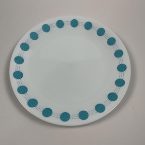 May include: White ceramic dinner plate with a teal blue border of small circles and dots.