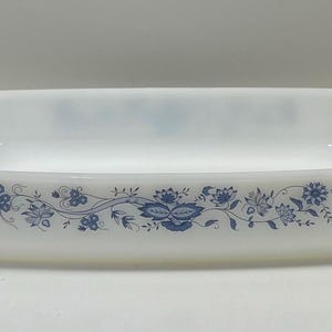 May include: White rectangular baking dish with a blue floral design around the rim.