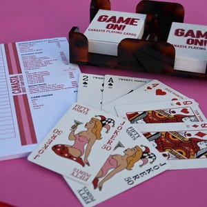 Canasta : tortoise spinner, two decks of canasta cards (with point value), 50 page scoring pad all in very cool canvas, “Canasta to go” bag