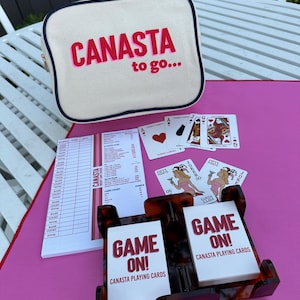 Canasta : tortoise spinner, two decks of canasta cards (with point value), 50 page scoring pad all in very cool canvas, “Canasta to go” bag